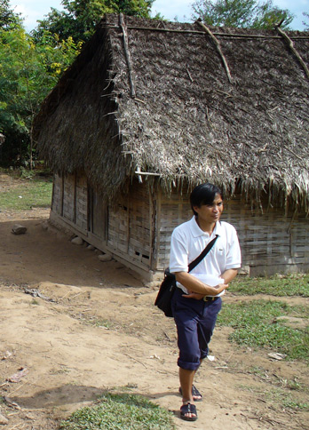 Our guide with traditional village house in background