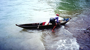 Fisherman preparing to set out his net in Lake Maninjau.