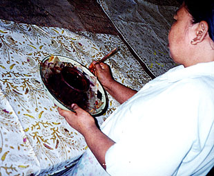 Hand Applying chemical dyes after first waxing.